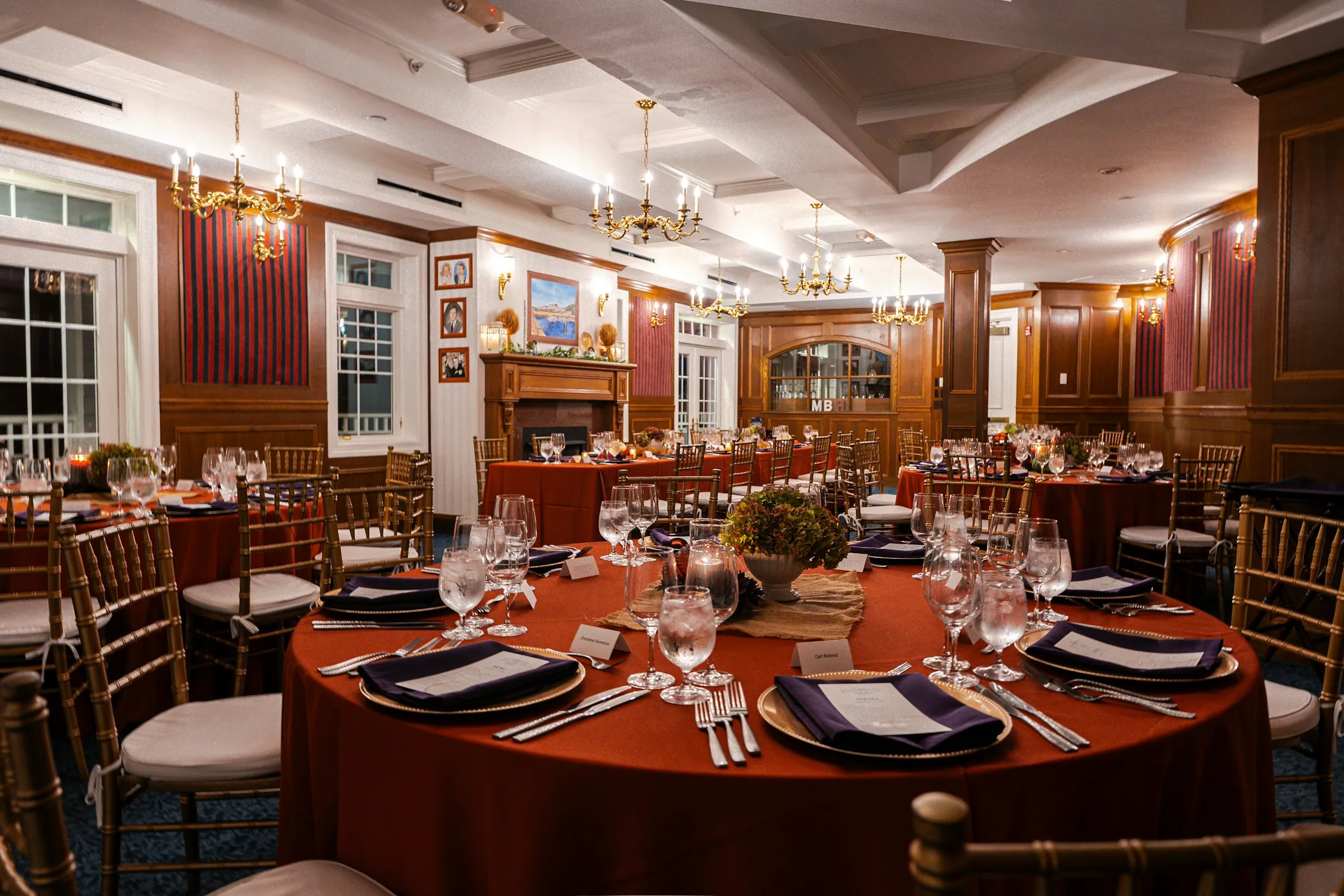 event space set for dinner with chairs, tables, linens, china and wine glasses