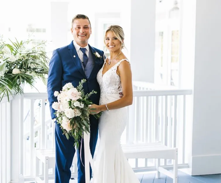 Bride and groom posing on balcony at Madison Beach Hotel