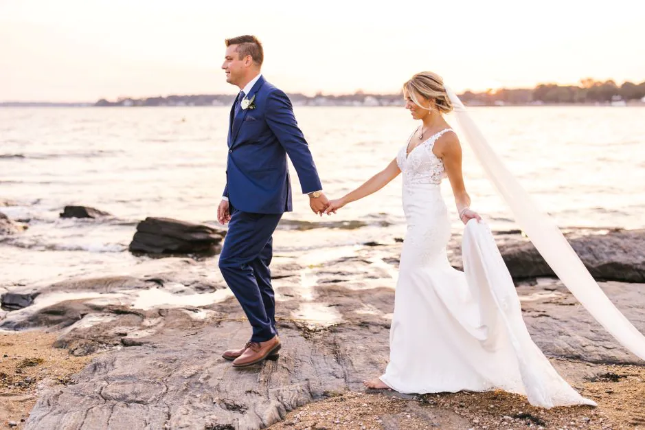 Wedding Couple on rocks by the shore at Madison Beach Hotel