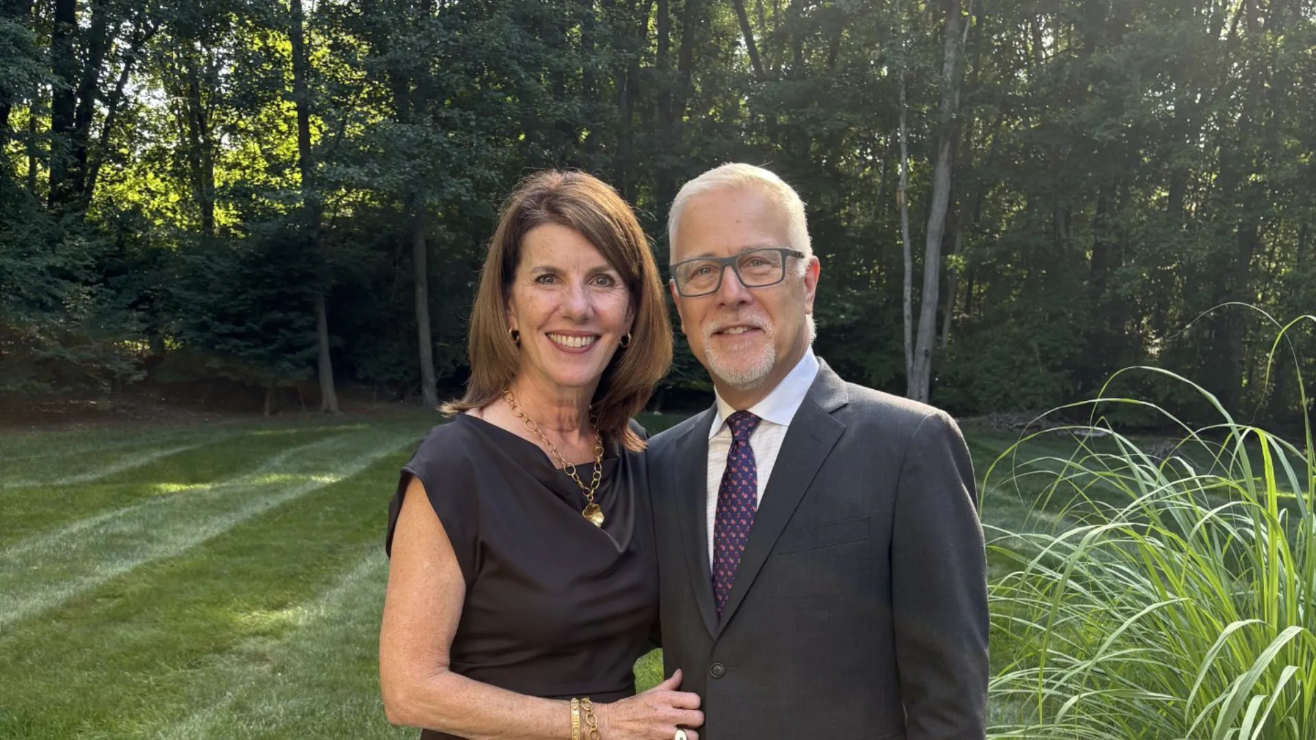 John and Melissa Mathers standing in landscape garden.